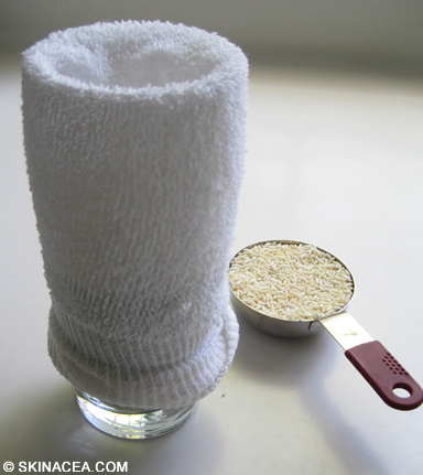 Putting a sock over a glass for the rice sock warm compress